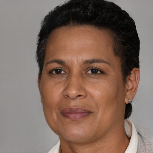 Joyful latino adult female with short  brown hair and brown eyes