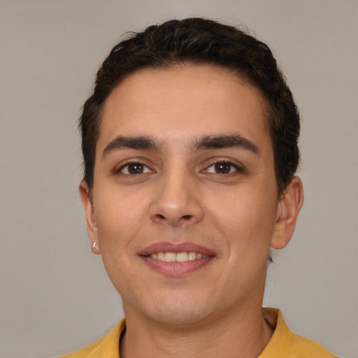 Joyful white young-adult male with short  brown hair and brown eyes