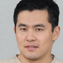 Joyful asian young-adult male with short  black hair and brown eyes