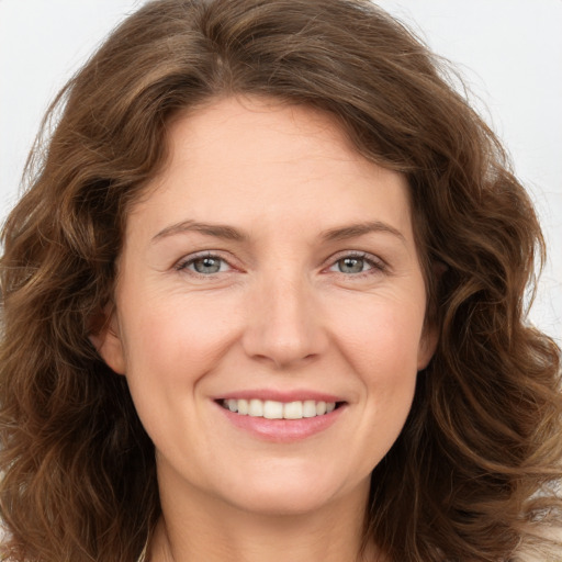 Joyful white young-adult female with long  brown hair and grey eyes