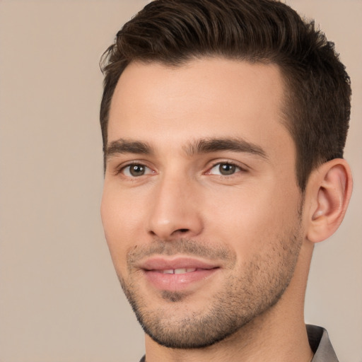 Joyful white young-adult male with short  brown hair and brown eyes