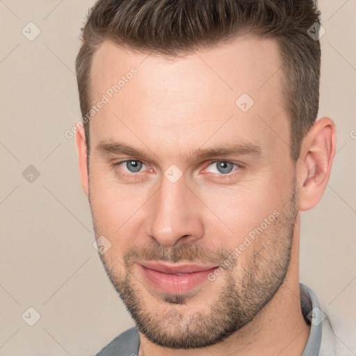 Joyful white adult male with short  brown hair and brown eyes