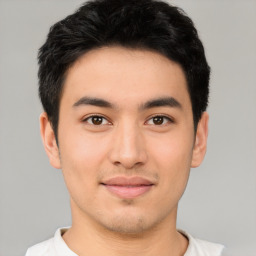 Joyful asian young-adult male with short  black hair and brown eyes