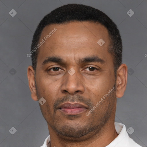 Neutral latino adult male with short  black hair and brown eyes