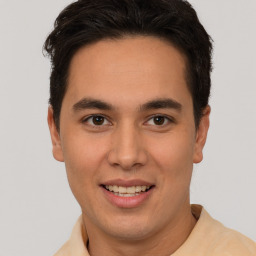 Joyful latino young-adult male with short  brown hair and brown eyes