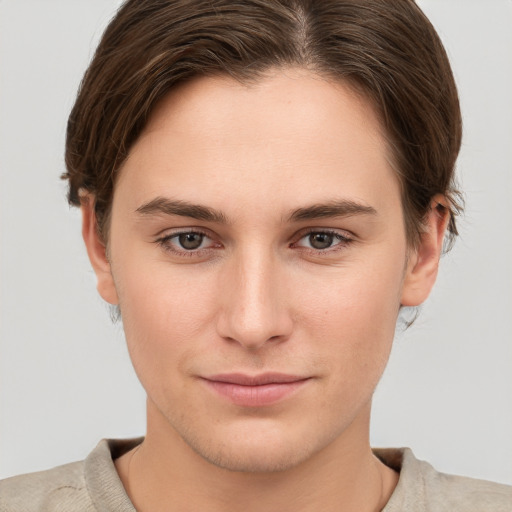 Joyful white young-adult female with short  brown hair and grey eyes