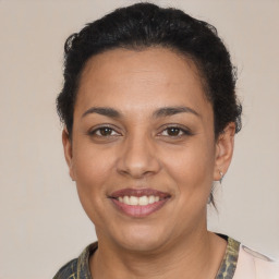 Joyful latino young-adult female with short  brown hair and brown eyes