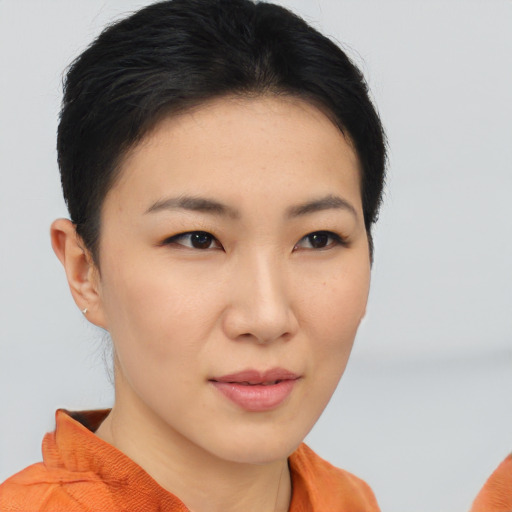 Joyful asian young-adult female with short  brown hair and brown eyes