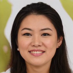 Joyful asian young-adult female with long  brown hair and brown eyes