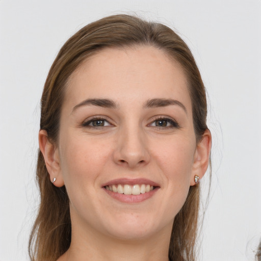 Joyful white young-adult female with long  brown hair and grey eyes