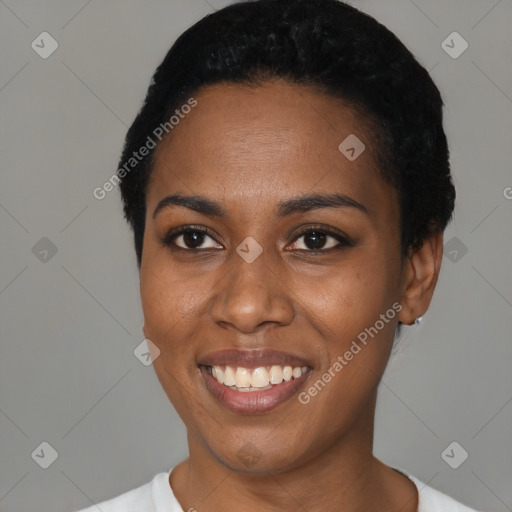 Joyful black young-adult female with short  black hair and brown eyes