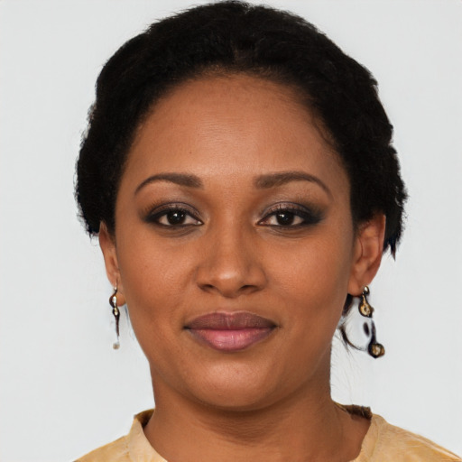 Joyful black young-adult female with short  brown hair and brown eyes