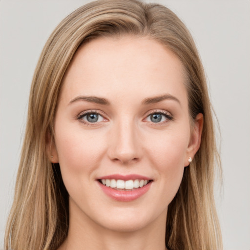 Joyful white young-adult female with long  brown hair and green eyes