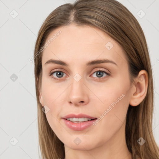 Joyful white young-adult female with long  brown hair and grey eyes