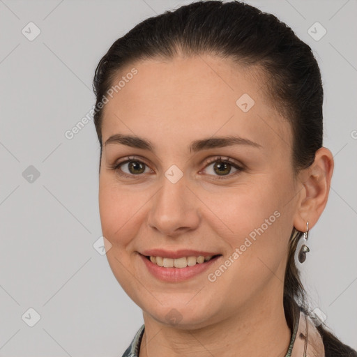 Joyful white young-adult female with long  brown hair and brown eyes