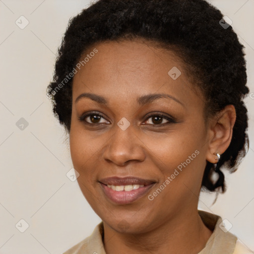 Joyful black adult female with short  brown hair and brown eyes