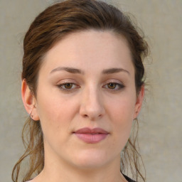 Joyful white young-adult female with medium  brown hair and green eyes