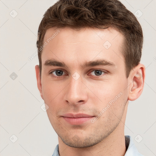 Neutral white young-adult male with short  brown hair and grey eyes