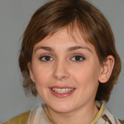 Joyful white young-adult female with medium  brown hair and blue eyes