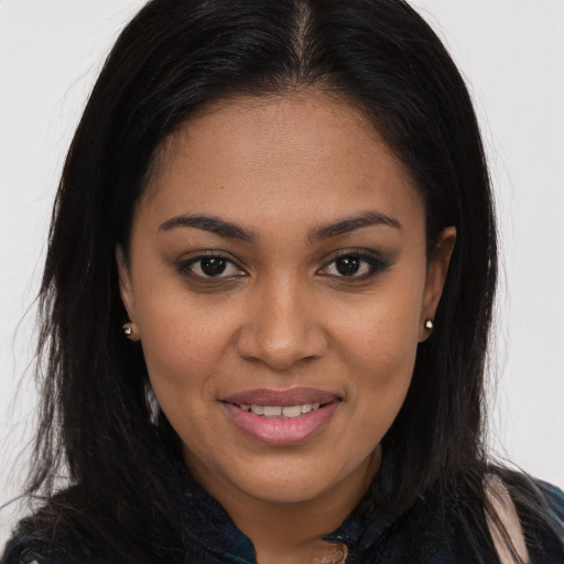 Joyful black young-adult female with long  brown hair and brown eyes
