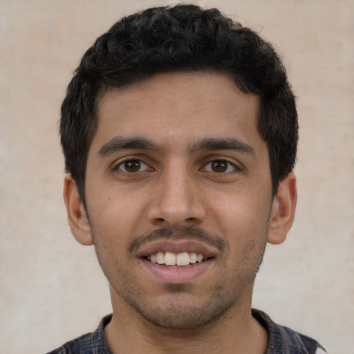 Joyful latino young-adult male with short  black hair and brown eyes