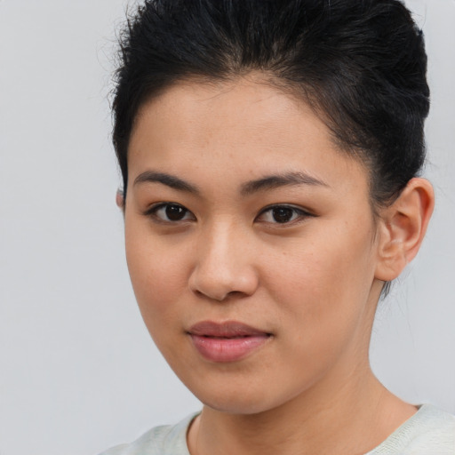 Joyful latino young-adult female with short  brown hair and brown eyes