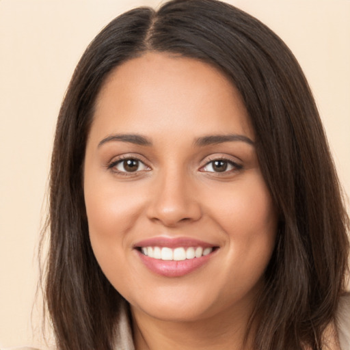 Joyful white young-adult female with long  brown hair and brown eyes