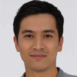 Joyful asian young-adult male with short  black hair and brown eyes