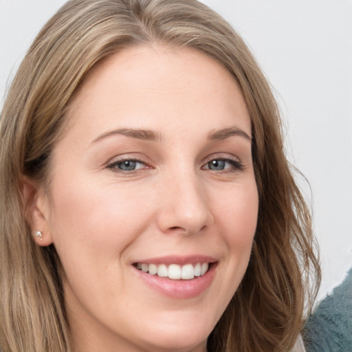 Joyful white young-adult female with long  brown hair and grey eyes