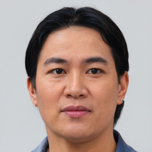 Joyful asian young-adult male with short  black hair and brown eyes