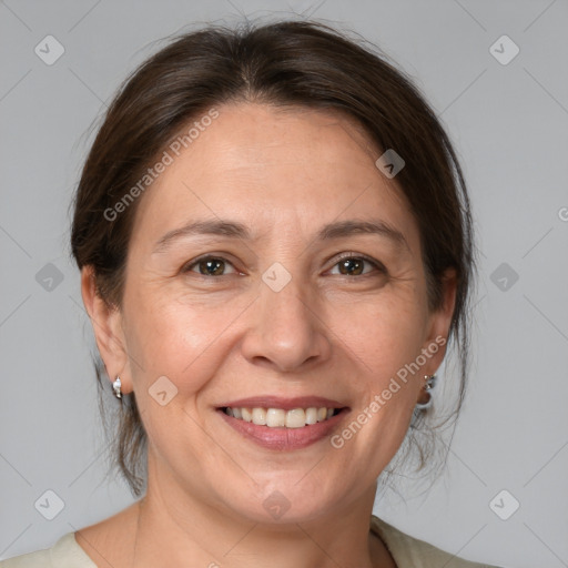 Joyful white adult female with medium  brown hair and brown eyes