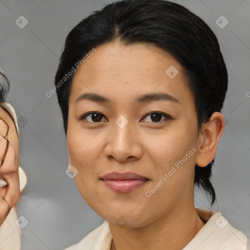 Joyful asian young-adult female with medium  brown hair and brown eyes