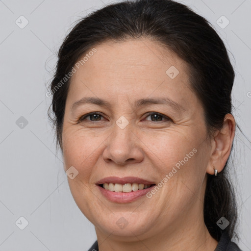 Joyful white adult female with medium  brown hair and brown eyes