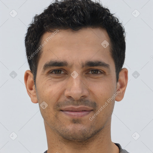 Joyful latino young-adult male with short  brown hair and brown eyes