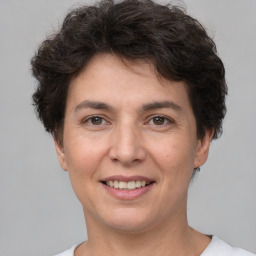 Joyful white adult female with short  brown hair and brown eyes