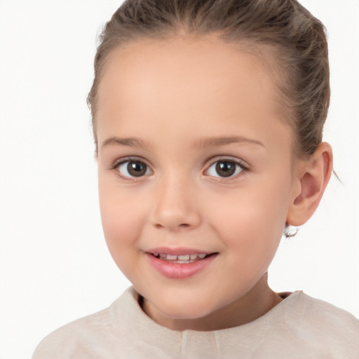 Joyful white child female with short  brown hair and brown eyes