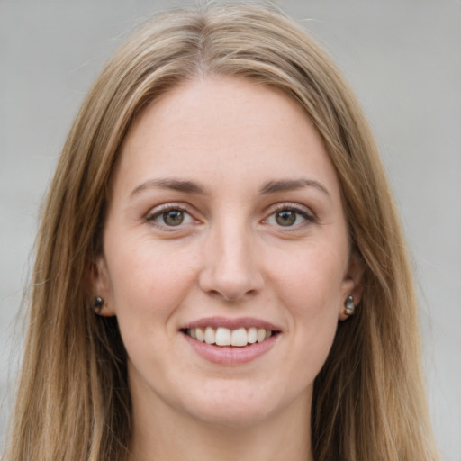 Joyful white young-adult female with long  brown hair and green eyes