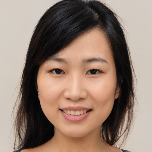 Joyful asian young-adult female with medium  brown hair and brown eyes