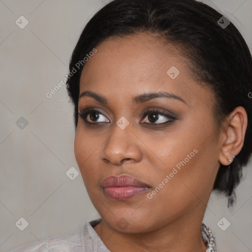 Joyful black young-adult female with medium  brown hair and brown eyes