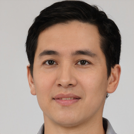 Joyful white young-adult male with short  black hair and brown eyes
