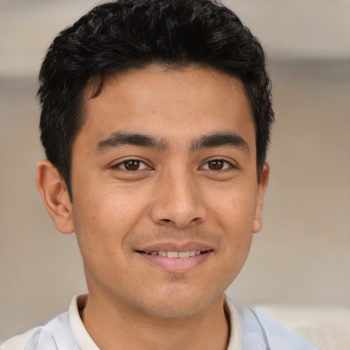 Joyful asian young-adult male with short  brown hair and brown eyes