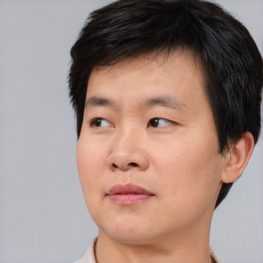 Neutral asian young-adult male with short  brown hair and brown eyes