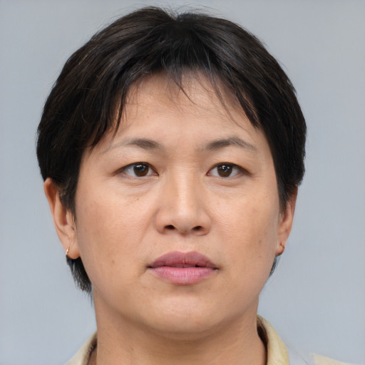Joyful asian adult female with short  brown hair and brown eyes
