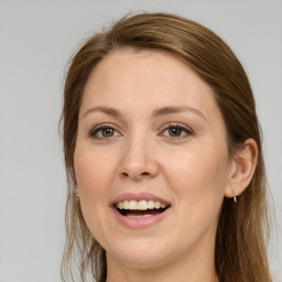 Joyful white adult female with long  brown hair and green eyes