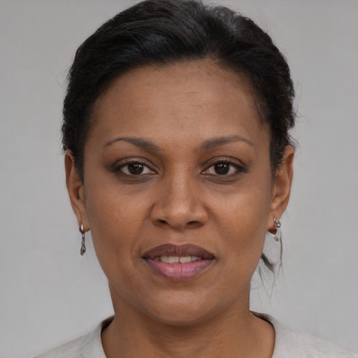 Joyful black adult female with short  brown hair and brown eyes