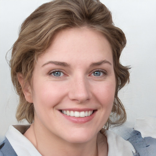 Joyful white young-adult female with medium  brown hair and blue eyes