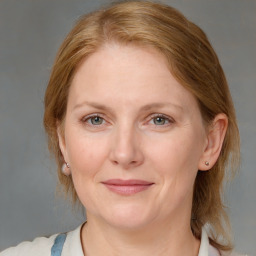 Joyful white adult female with medium  brown hair and blue eyes