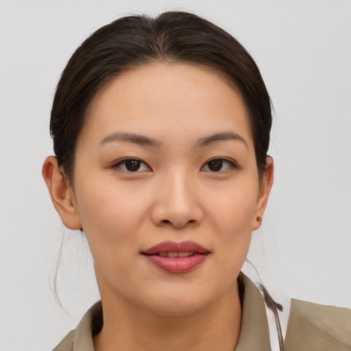 Joyful asian young-adult female with short  brown hair and brown eyes