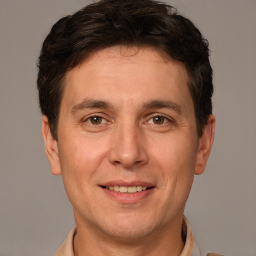 Joyful white adult male with short  brown hair and brown eyes