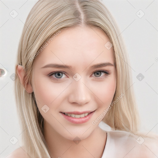 Joyful white young-adult female with long  brown hair and blue eyes